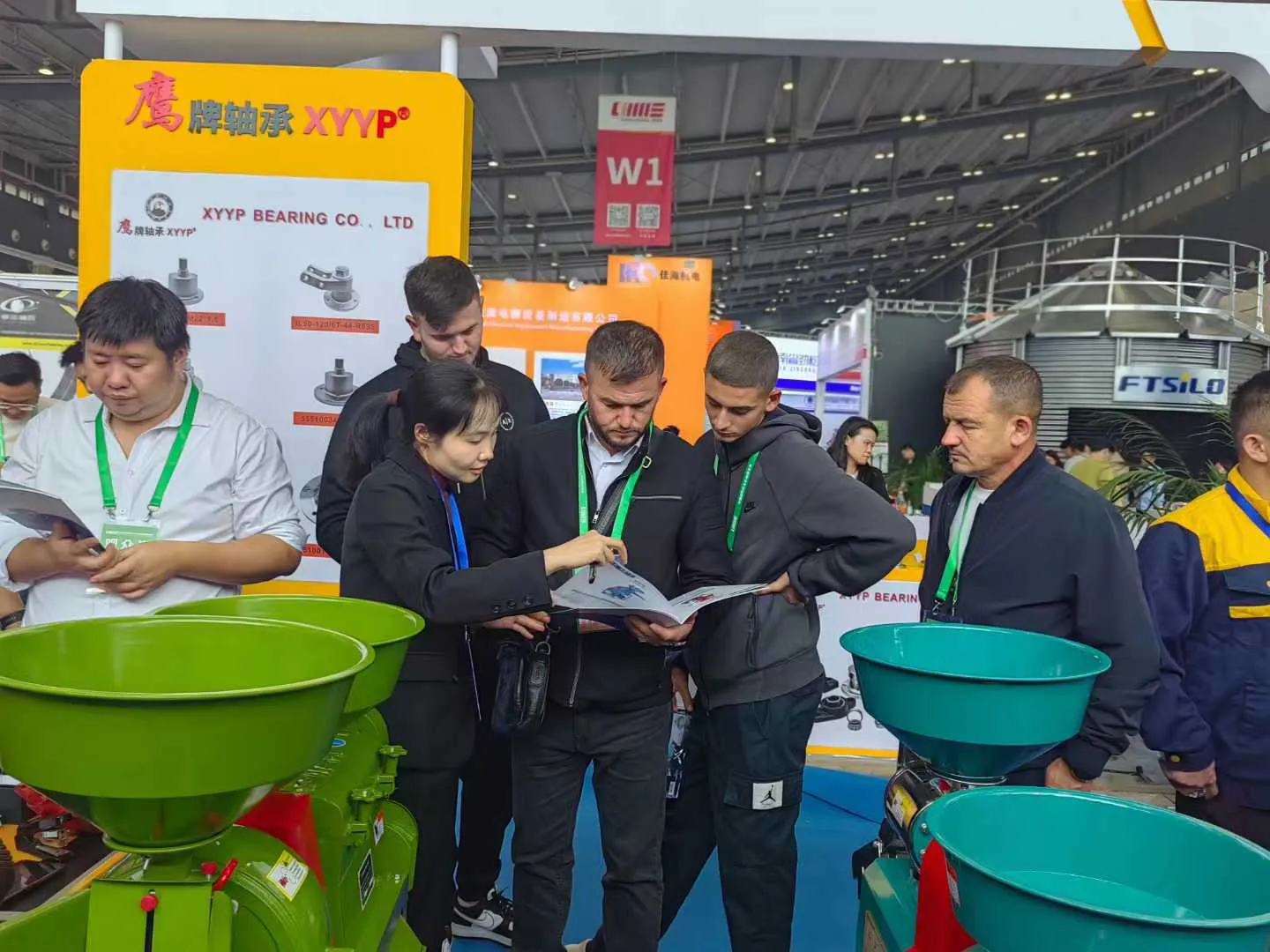 Visitors viewing grain processing machines at the exhibition